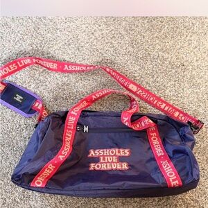 #403 A$sholes Live Forever Purple& Pink Straps Duffle Bag has flaws